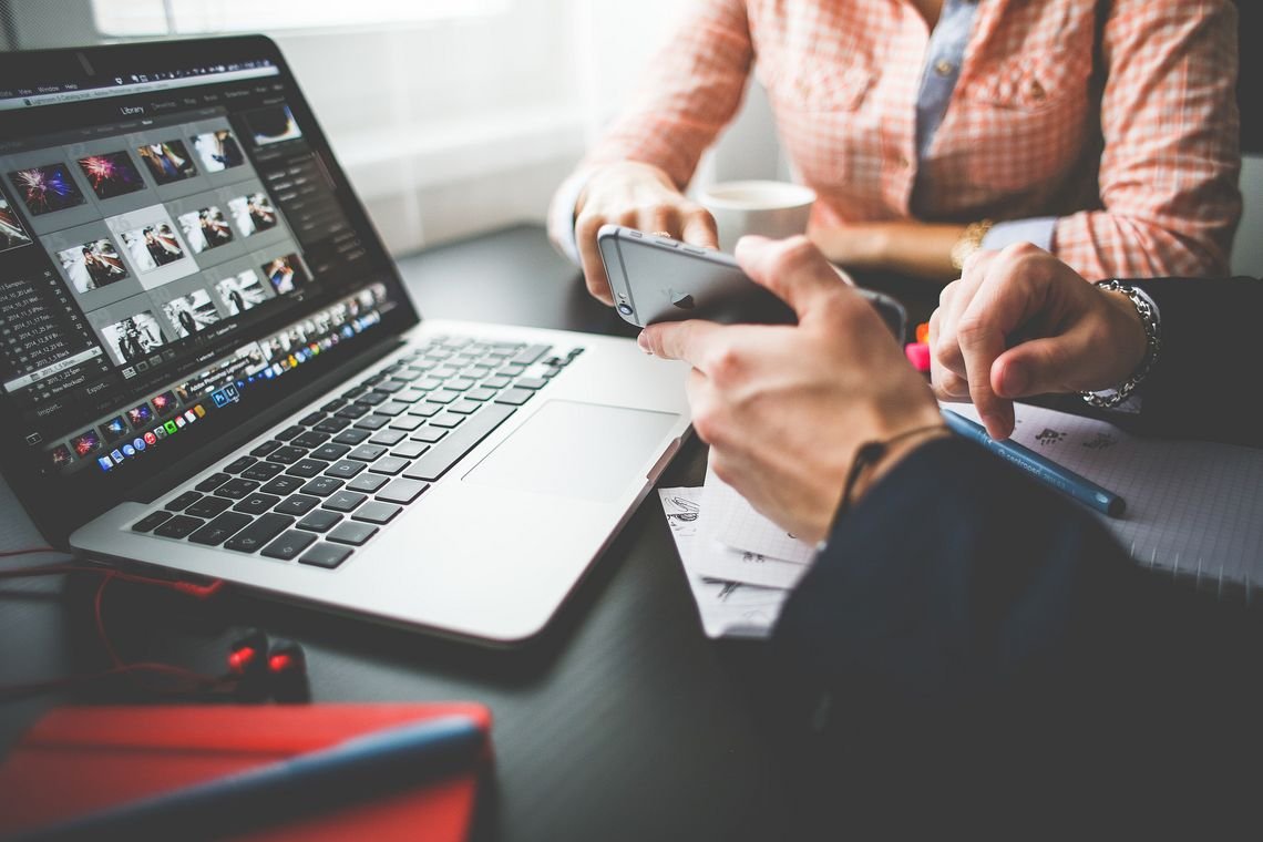 Man and woman reviewing images on laptop. Man and woman review images on laptop.